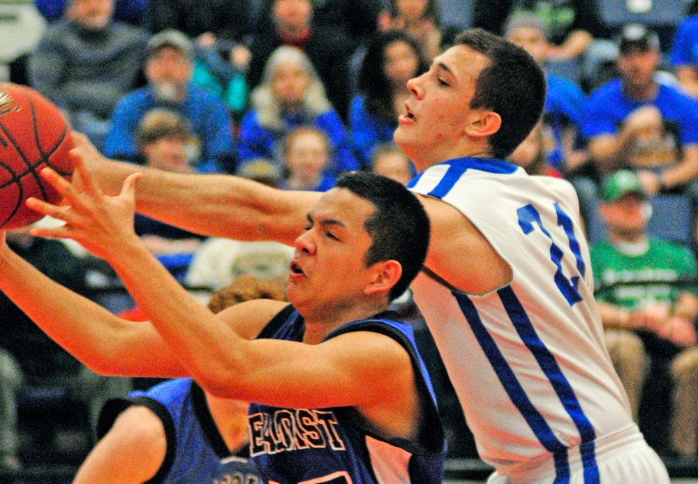 Seacoast Christian’s Marlon Bernardo, left, and Valley’s Collin Miller battle for a rebound during the Class D South championship game Saturday at the Augusta Civic Center.