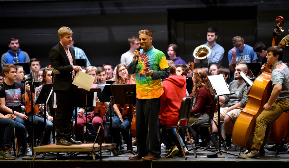 Srinivas Krishnan, master percussionist who created and produces Global Rhythms World Music, is introduced by strings conductor, Sam Lyons, during a concert  at Waterville Senior High School on Friday. Krishnan spent the week with Waterville students, teaching them about music of other cultures. They performed with Colby College musicians and community musicians mid-week.