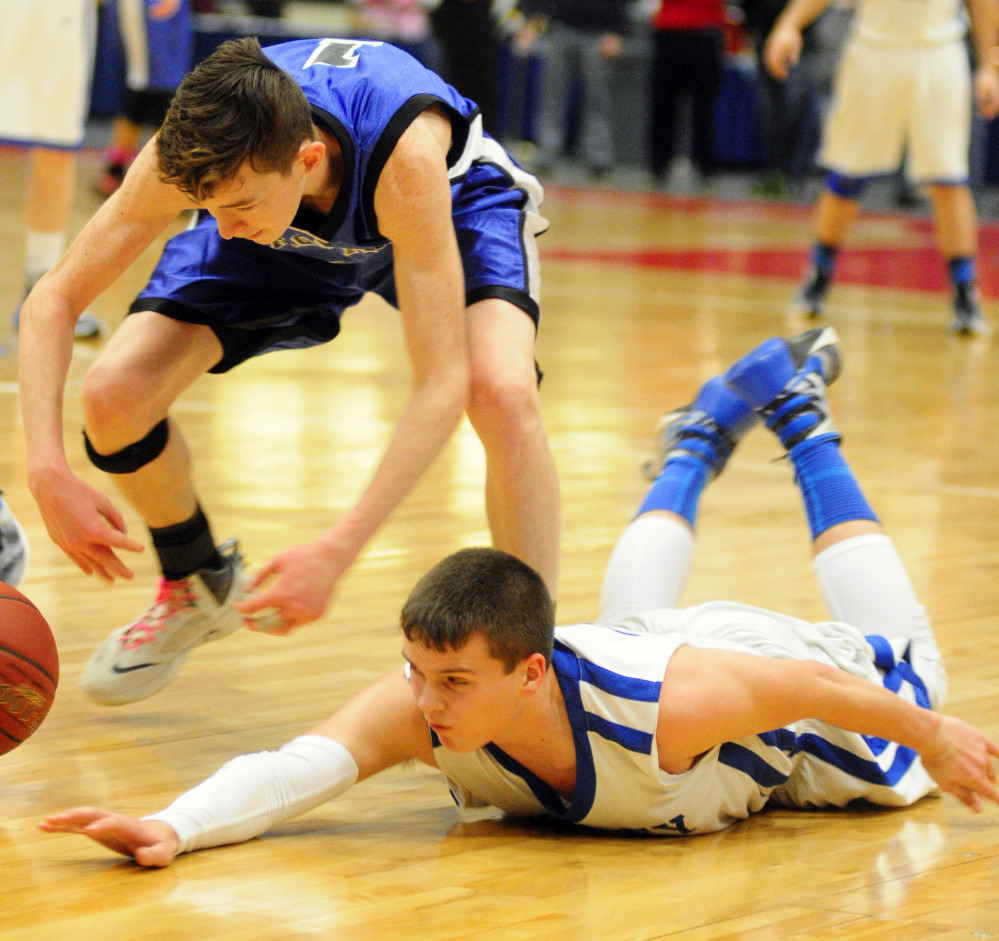 Seacoast Christian’s Jet Archer, left, and Valley’s Dillon Beane scramble after a loose ball during the Class D South championship game Saturday at the Augusta Civic Center. Beane and the Cavaliers will play Easton for the Gold Ball on Saturday in Augusta.