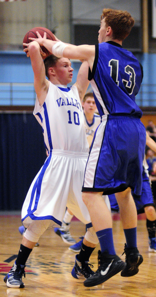 Valley’s Luke Malloy, left, gets fouled by Seacoast Christian’s Sky Archer late in the Class D South championship game Saturday at the Augusta Civic Center.