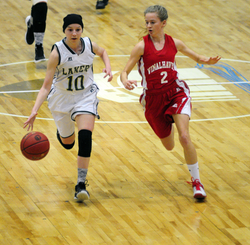 Rangeley freshman guard Brooke Egan tries to break away from Vinalhaven senior guard Hannah Noyes during the Class D South championship game last Saturday at the Augusta Civic Center.
