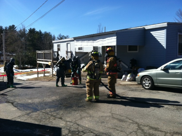 Authorities wearing hazmat suits search a Livermore Falls home Saturday after raiding an alleged meth operation.