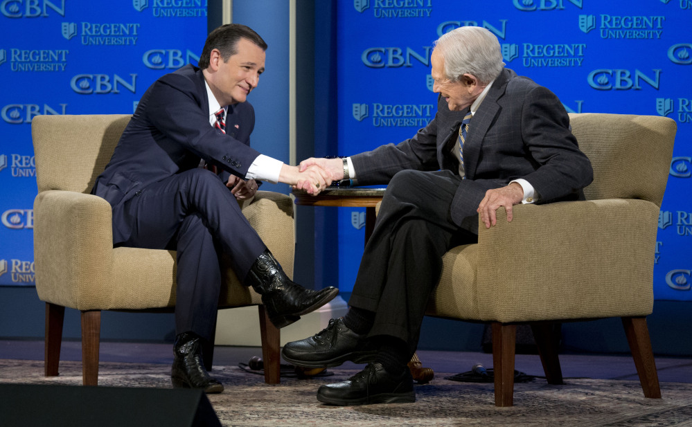 Republican presidential candidate, Sen. Ted Cruz, R-Tx., shakes hands with religious broadcaster Pat Robertson, right, during an appearance at Regent University in  Virginia Beach, Va., Friday.