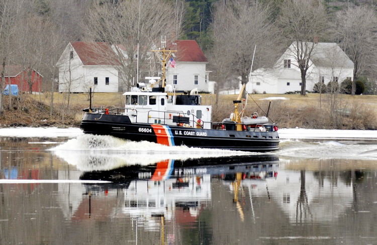 A Coast Guard ice cutter cruises up the Kennebec River past the Moulton Farm in Pittston in this 2012 file photo.