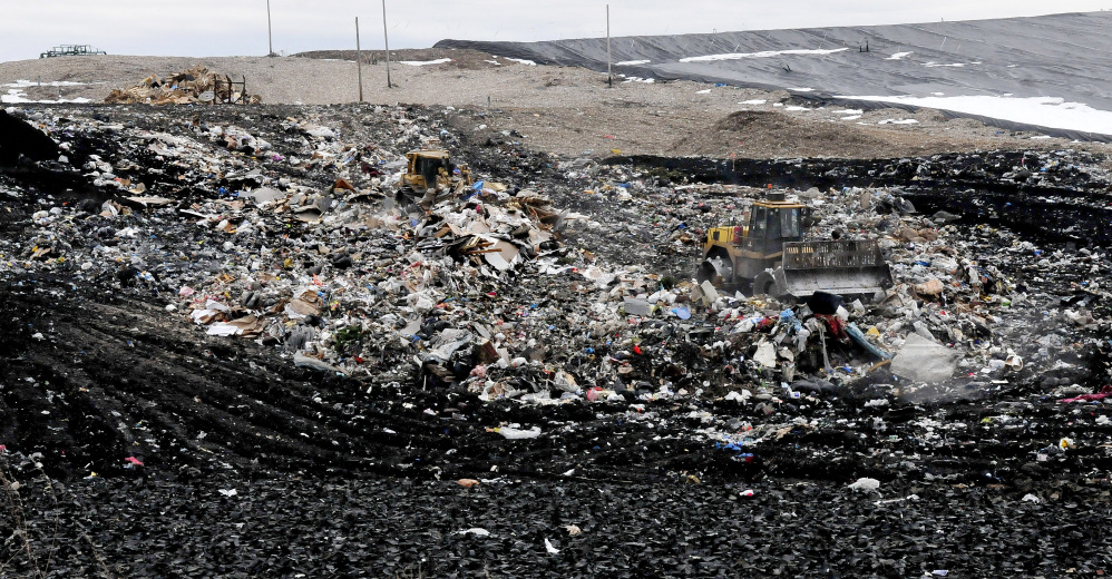 Two large bulldozers move a small mountain of trash at the Waste Management landfill in Norridgewock on Monday. Fairfield officials are moving forward with plan to contract with Waste Management to take the town’s solid waste after 2018, when its contract with Penobscot Energy Recovery Company in Orrington expires.