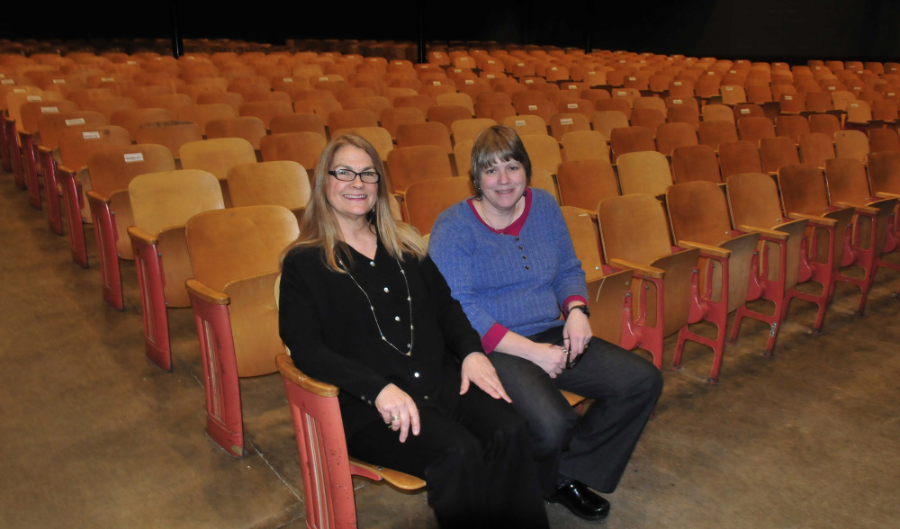 On Monday, Waterville Senior High School Drama Director Gayle Giguere, left, and Band Director Sue Barre sit on some of the 700 seats in Trask Auditorium that will be replaced. There will be a Save A Seat kickoff celebration March 10 at the school in hopes of raising $150,000 for new seats.