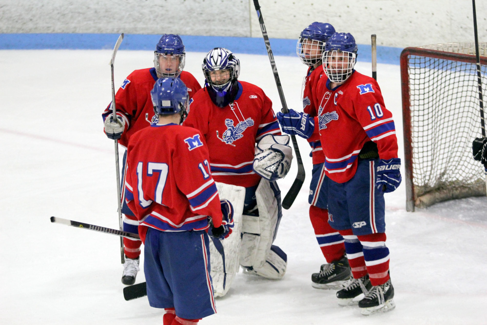 Messalonskee freshman goalie Amber Kochaver is congratulated by teammates after the Eagles sank Camden Hills 3-1 in a Class B North semifinal Saturday at Sukee Arena in Winslow.