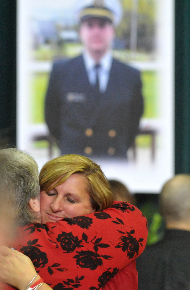Deb Roberts, mother of Michael Holland, is comforted by a friend during a celebration of her son’s life in October, shortly after the sinking of the El Faro.
