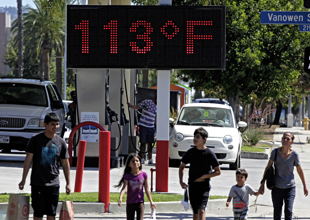 A warm day in Los Angeles in August 2015 clocks in at 113 degrees on a road-side thermometer. Government scientists say 2015 was a record year.