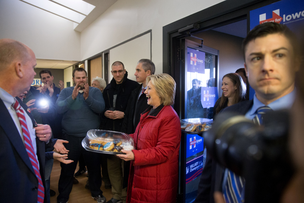 Democratic presidential candidate Hillary Clinton, followed by her daughter Chelsea, arrives to meet with staff at the Hillary for Iowa Office in Des Moines, Iowa, Monday, Feb. 1, 2016.