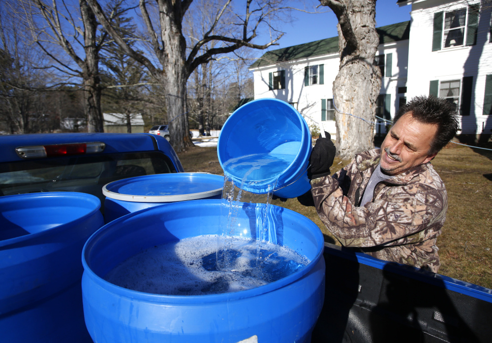 Jeff Berry of Waterboro fills 30-gallon buckets in the bed of his truck Tuesday after collecting sap in Buxton. Berry, who described this year’s flow as “real early,” started tapping maple trees with his partner on Jan. 27. They’ve already collected 1,000 gallons of sap that they planned to start boiling Wednesday.