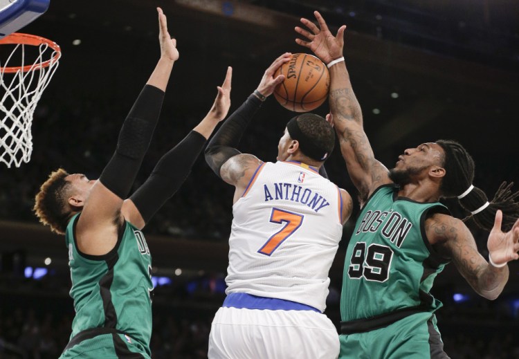 Knicks forward Carmelo Anthony is double-teamed by Celtics center Jared Sullinger, left, and forward Jae Crowder during the first quarter Tuesday night in New York.