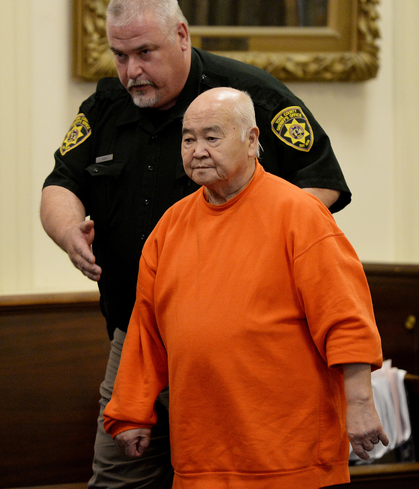 James Pak is lead into York County Superior Court in Alfred Wednesday, when he pleaded guilty of fatally shooting two teenagers and wounding a woman in a tenant dispute in 2012.