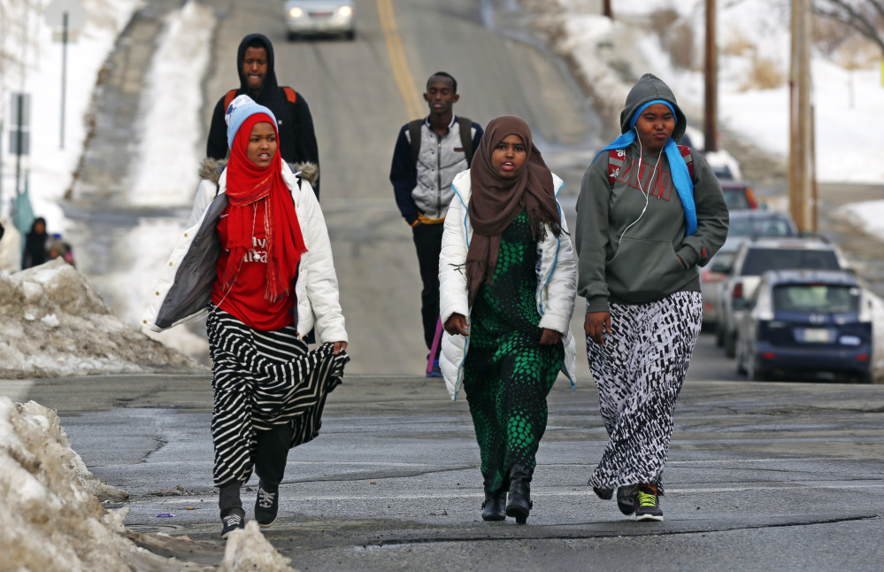 In this Tuesday, Jan. 26, 2016 photo, students walk home from school in Lewiston, Maine. Since February 2000, more than 5,000 Africans have come to Lewiston, a city of 36,500. Fifteen years later, though, Somali shops, restaurants and mosques serve as an example of how far the city of Lewiston has come.