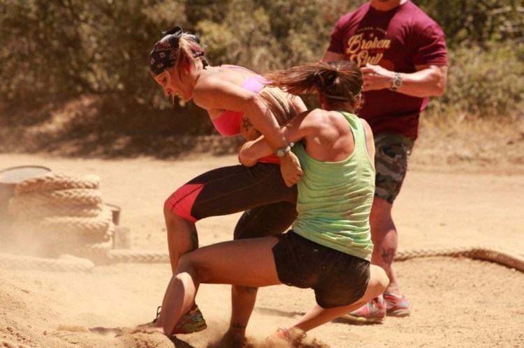Portland fitness instructor Jodi Theriault, left, is seen competing on the CMT series “Steve Austin’s Broken Skull Challenge.” The episode will air at 8 p.m. Sunday.