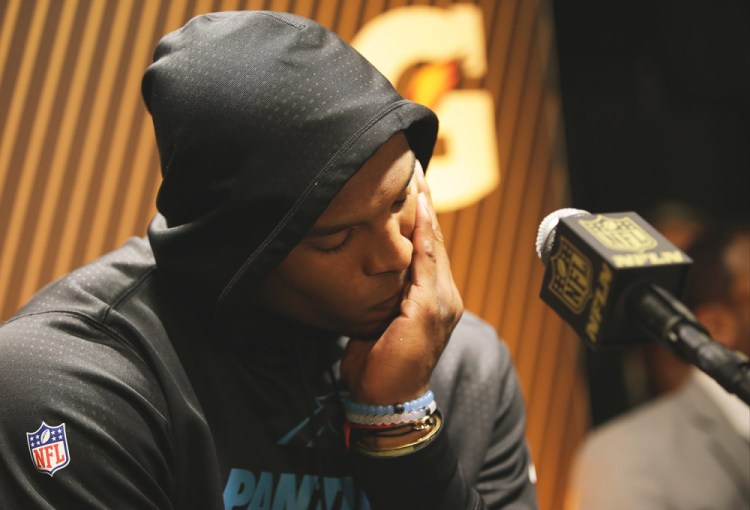 Carolina Panthers’ Cam Newton answers questions after his team’s Super Bowl loss against the Denver Broncos on Sunday. He said Tuesday that he doesn’t plan to change how he reacts to loss just to appease critics.