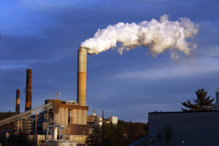 A plume of steam billows from the coal-fired Merrimack Station in Bow, N.H. The U.S. Supreme Court on Tuesday halted enforcement of President Obama’s plan to address climate change by reducing carbon dioxide emissions at existing power plants.