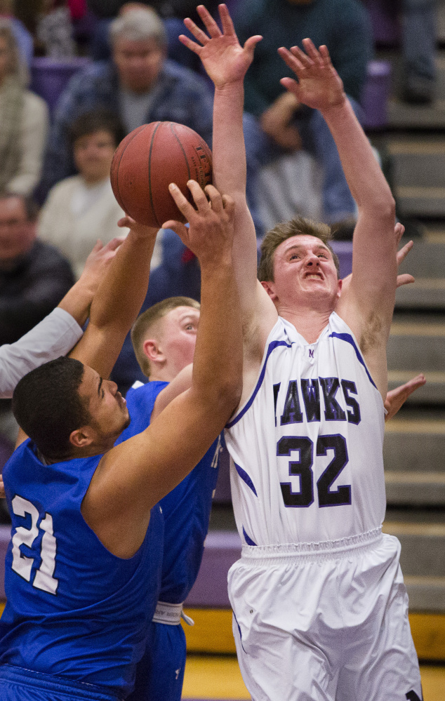 Ben Beers of Marshwood, right, and Travon Bradford of Kennebunk compete for a rebound Tuesday night during their Class A South boys’ basketball prelim. Marshwood advanced to the quarterfinals against No. 1 Greely with a 63-54 victory. 