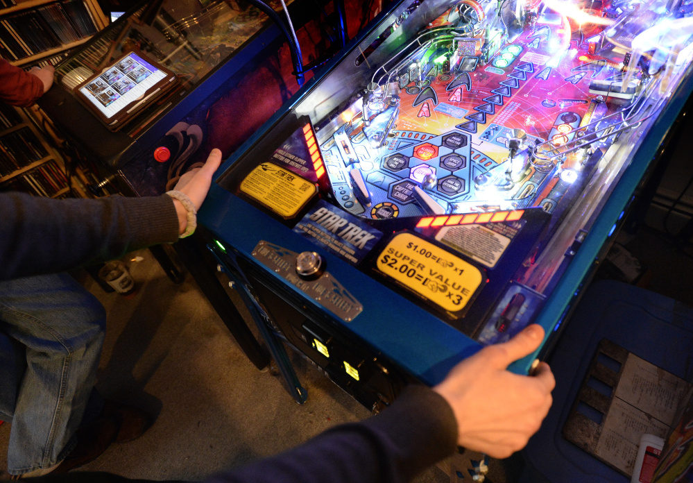 Marc Patenaude of Portland plays a game of pinball during the IFPA Maine State Pinball Championship on Saturday.