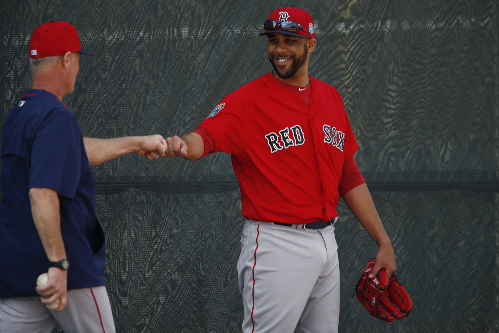 Bob Kipper, left, AAA Pawtucket Sox pitching coach, left, fist bumps Boston Red Sox starting pitcher David Price during spring training baseball, Friday, Feb. 19, 2016, in Fort Myers, Fla. (Corey Perrine/Naples Daily News via AP)  FORT MYERS OUT; MANDATORY CREDIT