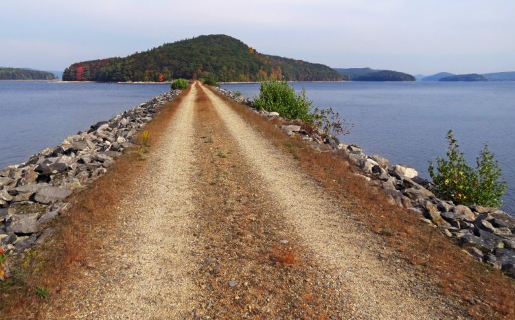 A dirt road leads to Mount Zion Island at the Quabbin Reservoir in Petersham, Massachusetts. Nancy Allen, chairwoman of the town selectboard, says she heard from fearful residents when the rattlesnake plan became public, but those fears have died down.