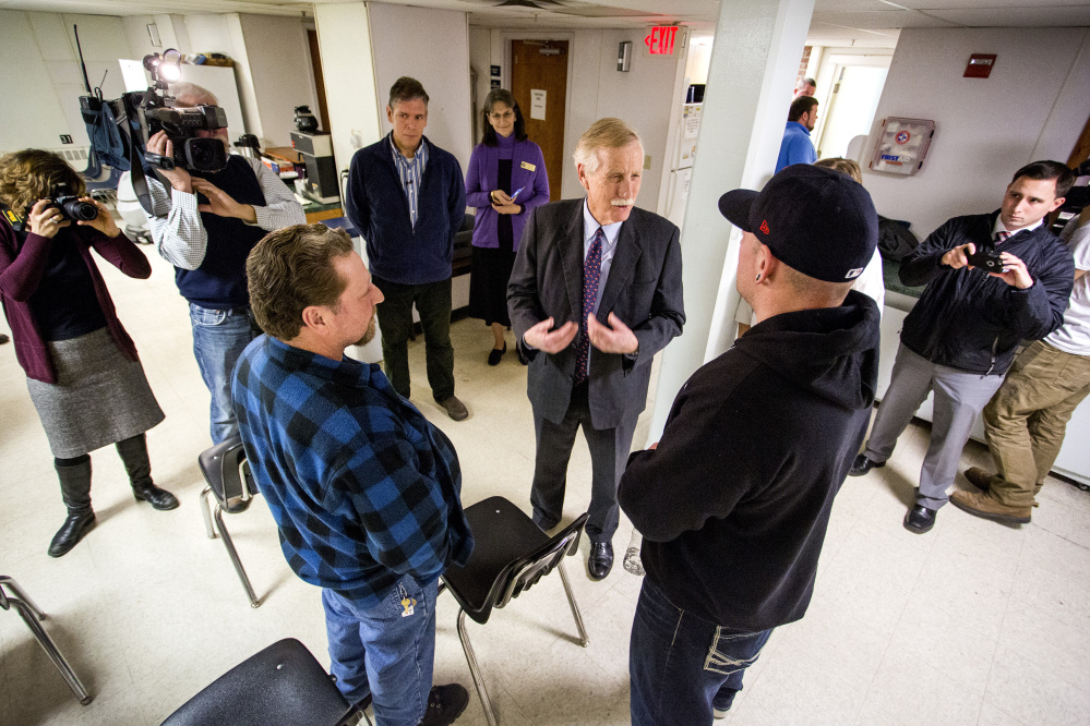 U.S. Sen. Angus King speaks with clients David Lavigne, 49, at left, and Derek Willerson, 36, at right, both clients, as he toured Milestone Foundation Inc. in Portland Monday. Gabe Souza/Staff Photographer