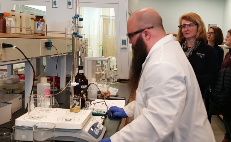Ryan Michaud, a University of Southern Maine student, checks acidity levels in a Rising Tide beer as Rising Tide Brewing Co. co-owner Heather Sanborn watches on Thursday morning.