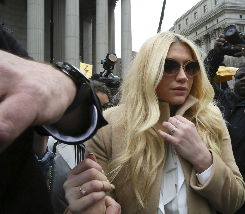 Pop star Kesha leaves court in New York on Friday. She is fighting to wrest her career away from a producer who she says abused her.