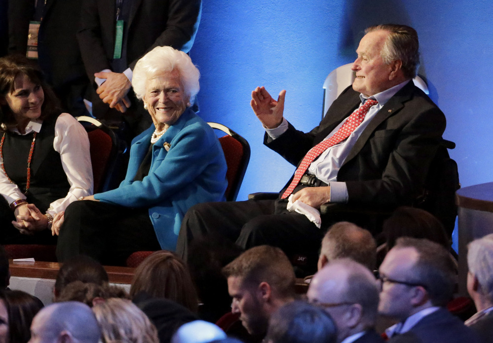 Former President George H. W. Bush, right, and his wife, Barbara Bush are greeted before Thursday night’s Republican presidential debate at the University of Houston. Their son Jeb Bush dropped out of the Republican race last weekend.