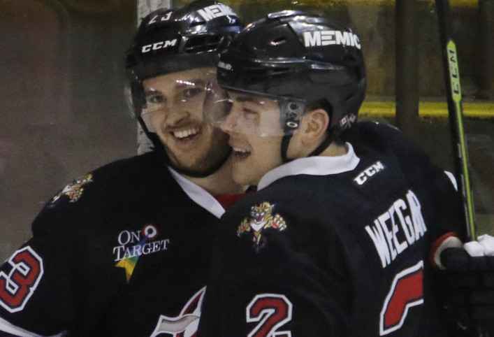 Connor Brickley is congratulated by teammate MacKenzie Weegar after scoring the go-ahead goal early in the third period Sunday against the Springfield Falcons.