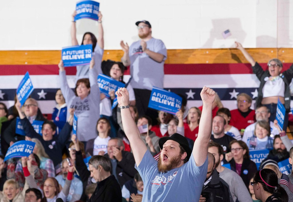 A supporter at a watch party at Concord High School cheers after Bernie Sanders is announced the winner of the Democratic primary.