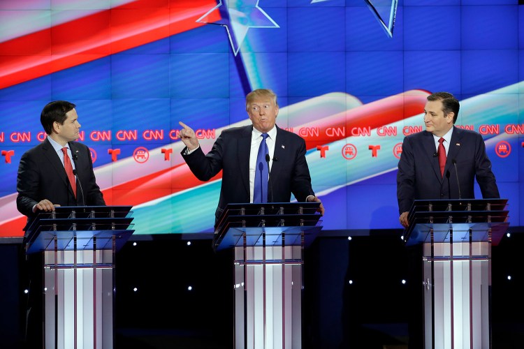 Donald Trump speaks as Marco Rubio, left, and Ted Cruz listen during Thursday night's debate. Trump, the front-runner in the race, and his two top rivals clashed from the start of the debate.
The Associated Press