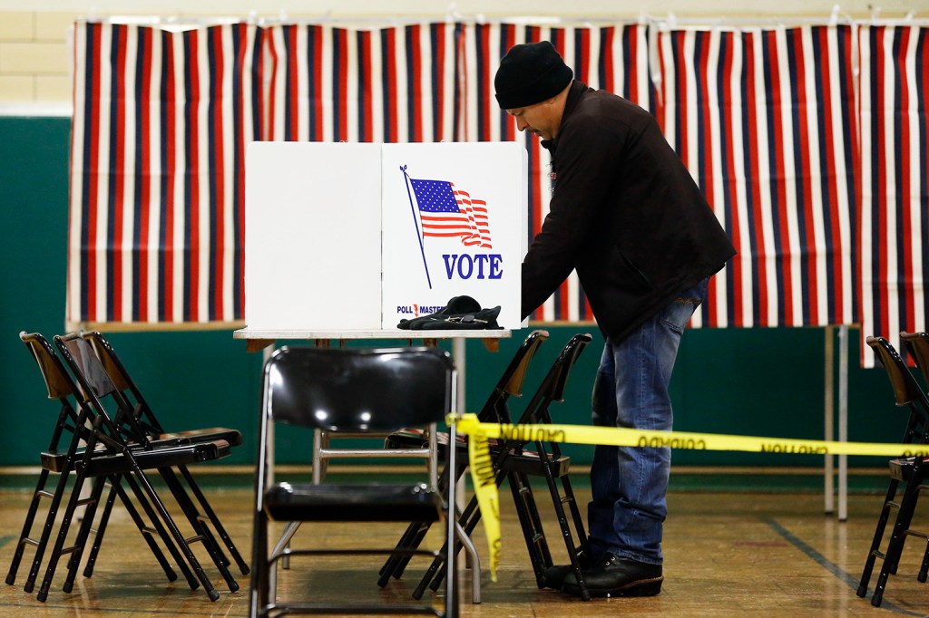 A voter marks his ballot in the first-in-the-nation presidential primary, Tuesday in Nashua, N.H. The Associated Press