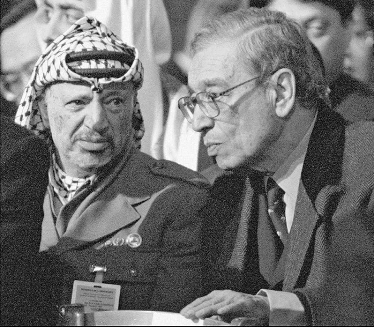 In this  Jan. 11, 1996, photo, then-U.N. Secretary General Boutros Boutros-Ghali, right, and Palestinian leader Yasser Arafat attend the funeral mass at Notre Dame Cathedral in Paris where world leaders paid their last respects to former French President Francois Mitterrand. The Associated Press