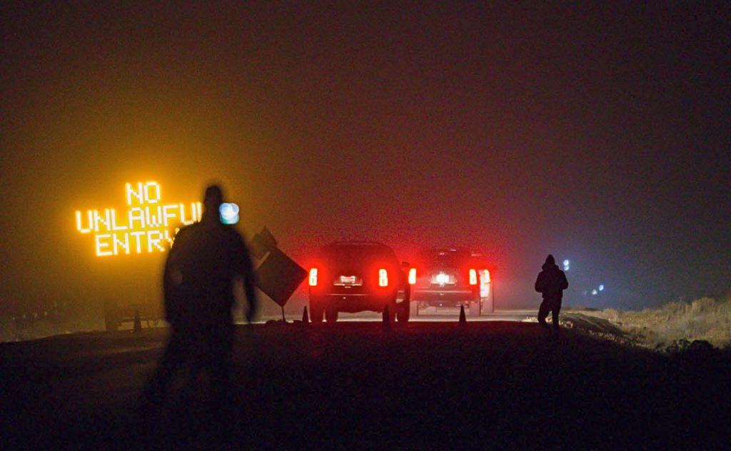 Three SUVs proceed through the Narrows roadblock near Burns, Ore., as FBI agents  surround the remaining four occupiers at the Malheur National Wildlife Refuge. Thomas Boyd/The Oregonian via AP/2016