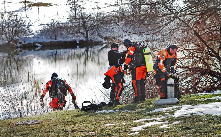 Troopers prepare to search the Duck Pond in Blacksburg, Va. The investigation continued in the death of Nicole Madison Lovell as a state police search and recovery team searched the pond for evidence on the Virginia Tech Campus. The Roanoke Times via The Associated Press