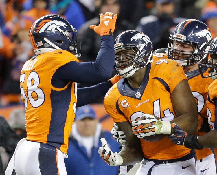 Denver Broncos outside linebacker DeMarcus Ware, right, celebrates a fumble recovery with outside linebacker Von Miller, left, during the second half. The Associated Press