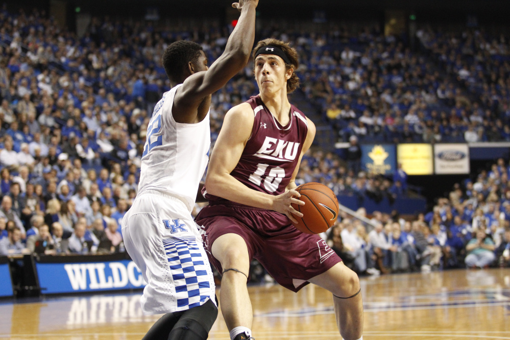 Eastern Kentucky forward Nick Mayo, left, drives to the basket during a game against Kentucky earlier this season. Mayo was named the Ohio Valley Conference Freshman of the Year on Monday. Mayo, a Messalonskee graduate, started all 31 games for the Colonels and averaged 14.5 points a game.