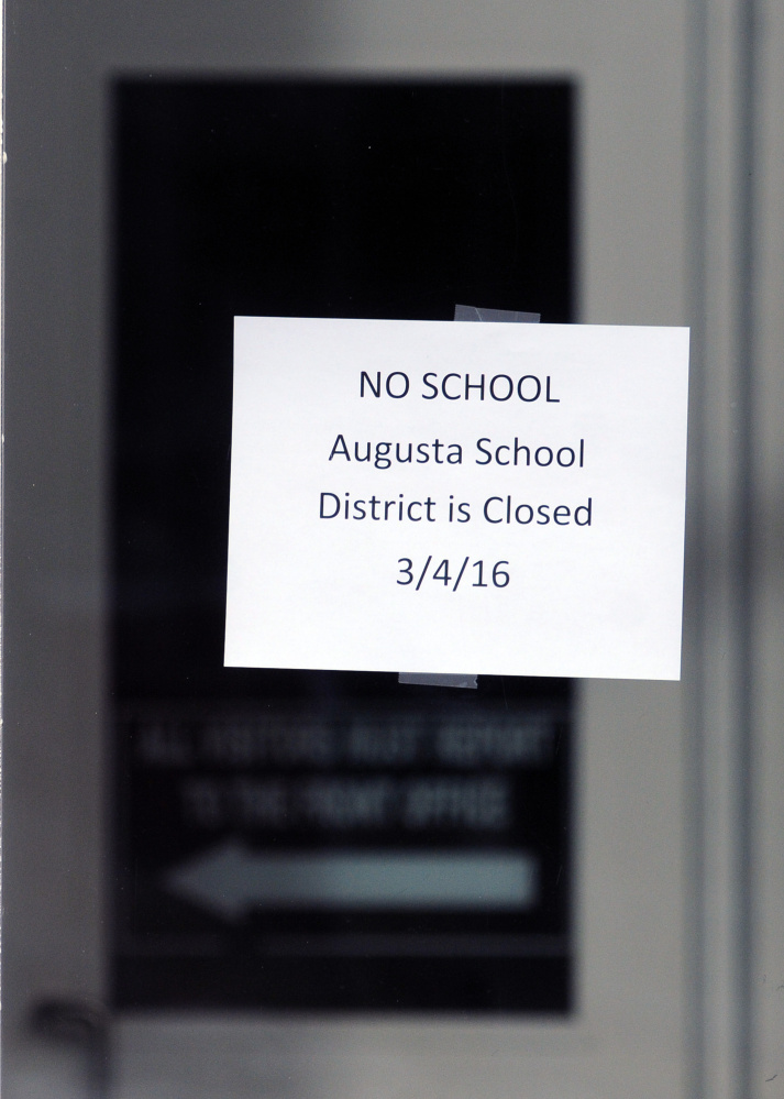 A sign hangs on the front door of Cony High School following a bomb threat on Friday at the school in Augusta.