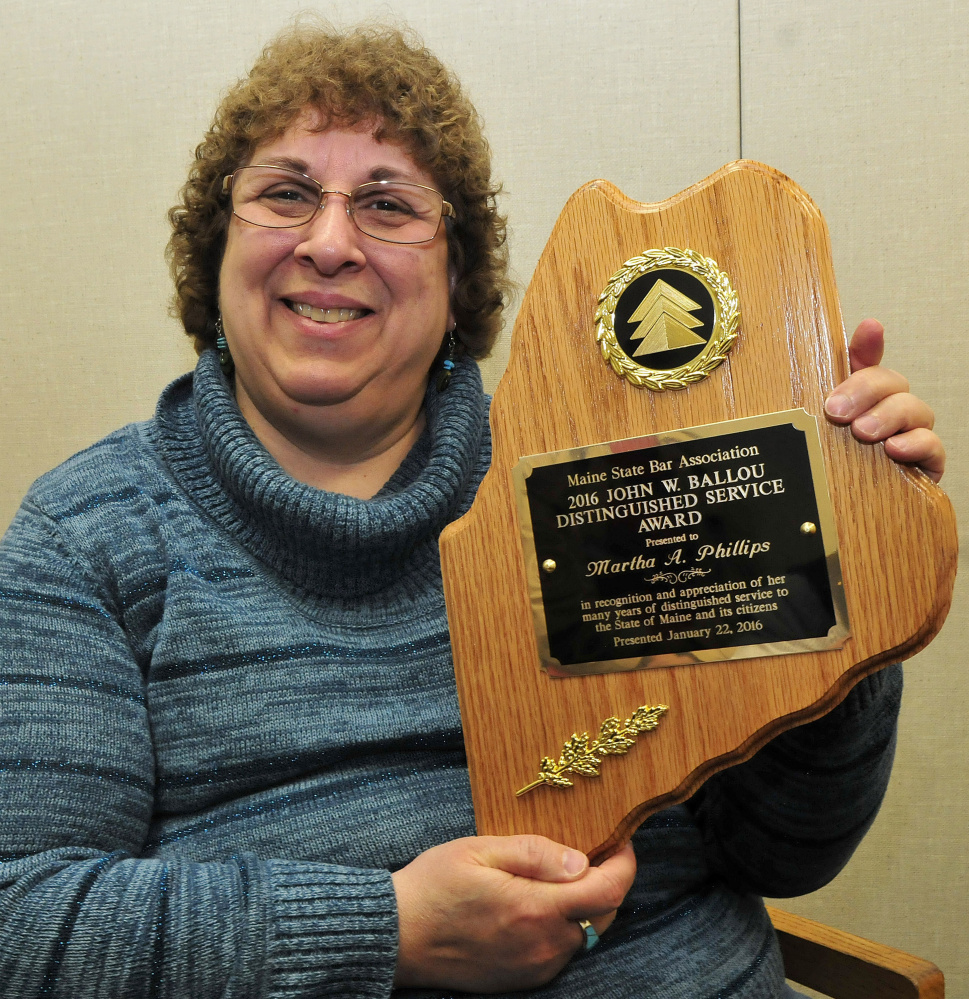 Martha Phillips on Wednesday holds the John W. Ballou award she received recently from the Maine Bar Association. Phillips volunteers to help people fill out court paperwork the first Wednesday of every month at Waterville District Court.