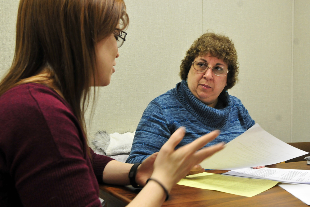 Martha Phillips, right, assists Rebecca Want fill out paperwork at the Waterville District Court on Wednesday. Phillips recently received the Maine Bar Association’s John W. Ballou Award for her volunteer work. 