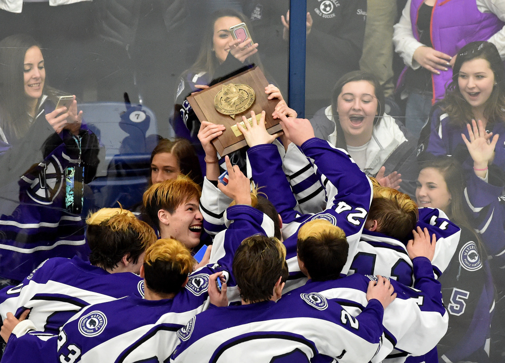 The Waterville Senior High School boys hockey team celebrates with their fans after defeating Messalonskee High school 6-2 to win the Class B North regional final Tuesday at Alfond Arena at the University of Maine at Orono.