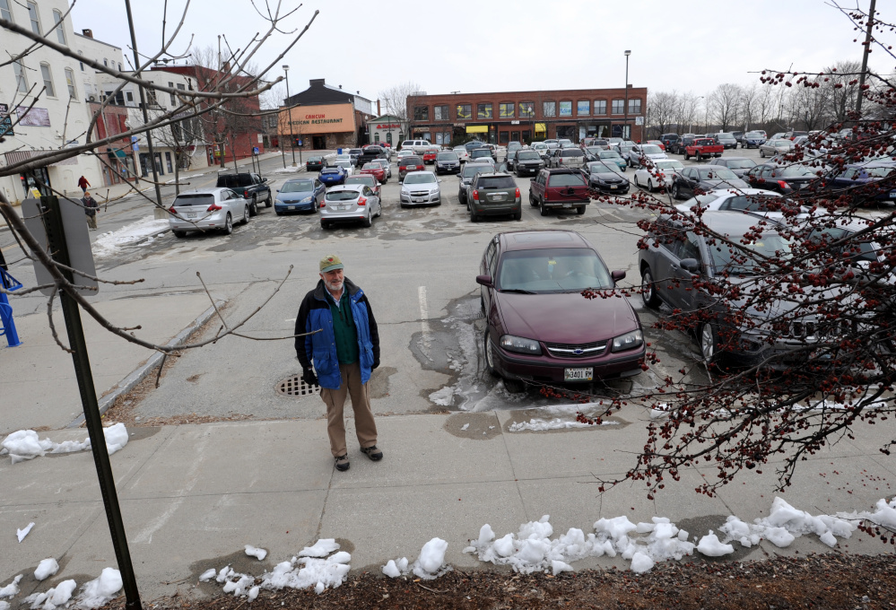 Bill Basford stands in The Concourse parking lot in front of the Napoli Italian Market in downtown Waterville on Friday. Basford says people should park farther away from downtown destinations and walk more.