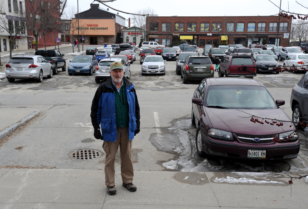 Bill Basford stands in The Concourse parking lot in front of the Napoli Italian Market in downtown Waterville on Friday. Basford says people should park farther away from downtown destinations and walk more.