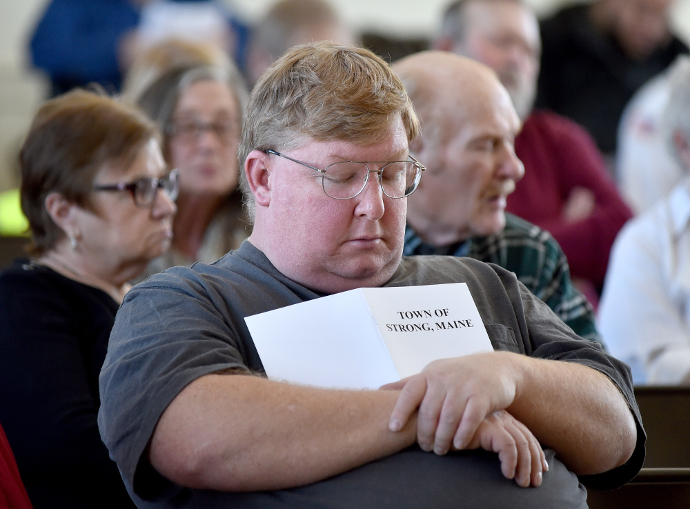 Tom Piekart catches up on some sleep Saturday during Town Meeting at the Strong Town Hall.