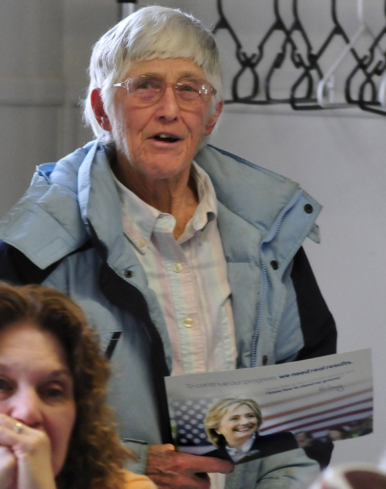 Holding a poster for candidate Hillary Clinton, Wilton resident Maxine Collin states her support during the Wilton Democratic caucus on Sunday.
