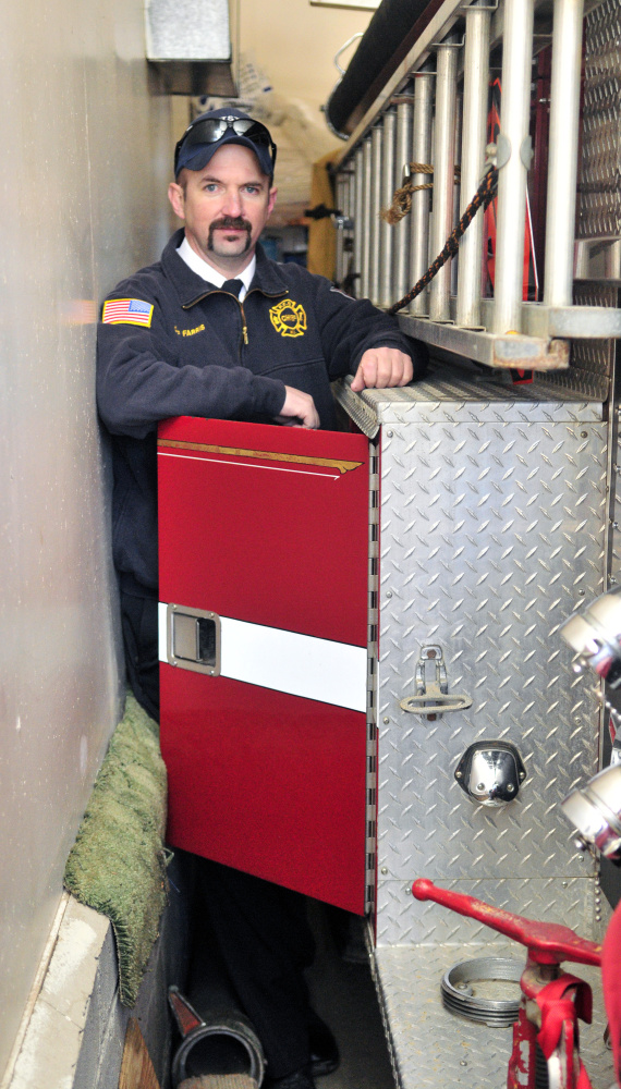 Staff photo by Joe Phelan
Pittston Fire Chief Jason Farris demonstrates on Saturday that the storage compartment doors on fire engines can’t be opened inside the tight confines of the fire station in East Pittston village.