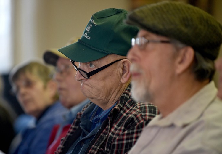 Earland Lake, right center, listens to Marc Courtemanche moderate the Town Meeting on Saturday at the Athens Town Office.