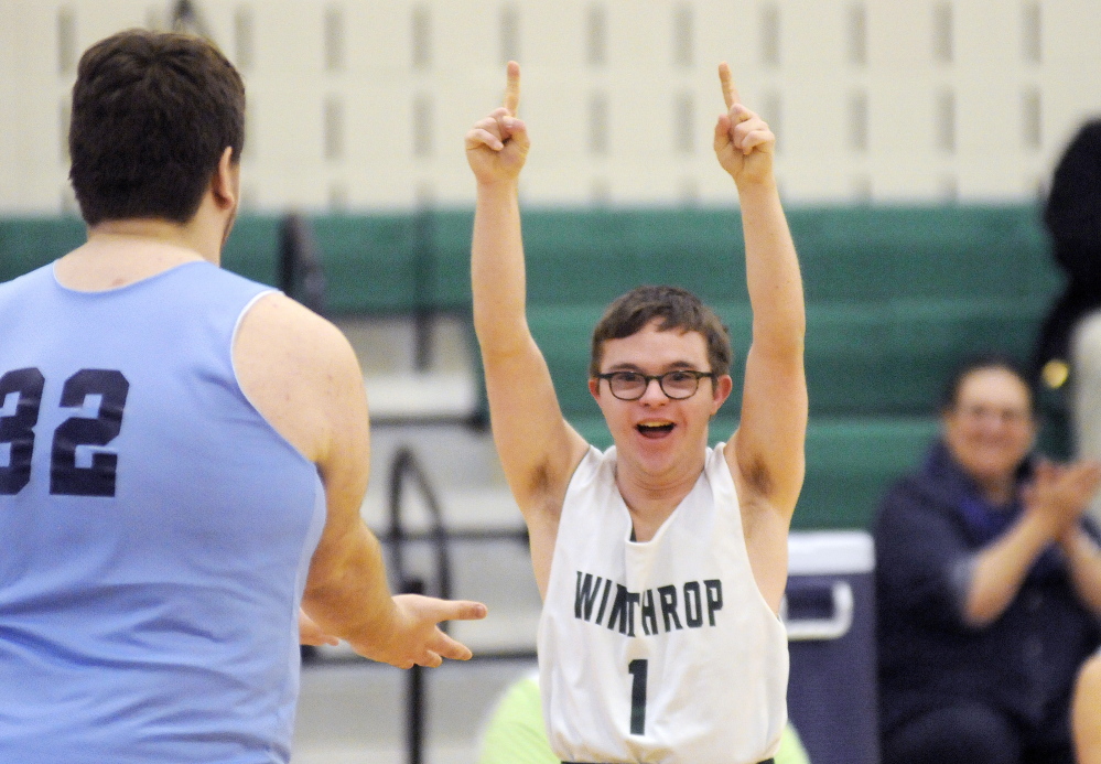 In this March 12, 2015 photo, Winthrop High School’s Nate Jewell, right, reacts after scoring a basket as he is congratulated by an Oceanside player during a unified basketball game last season in Winthrop. On Friday night, Jewell received the Maine McDonald’s Patrick Thibodeau Spirit of the Game Award at a ceremony in Bangor.