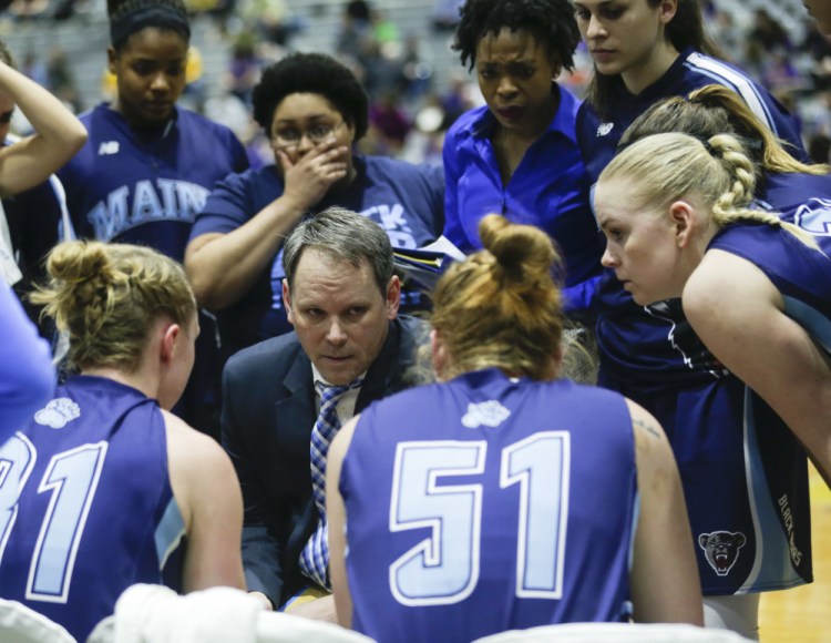 Maine head coach Richard Barron, center, talks to his players during a timeout during the second half an NCAA women’s college basketball game against Albany in the America East Conference tournament championship on Friday in Albany, N.Y.